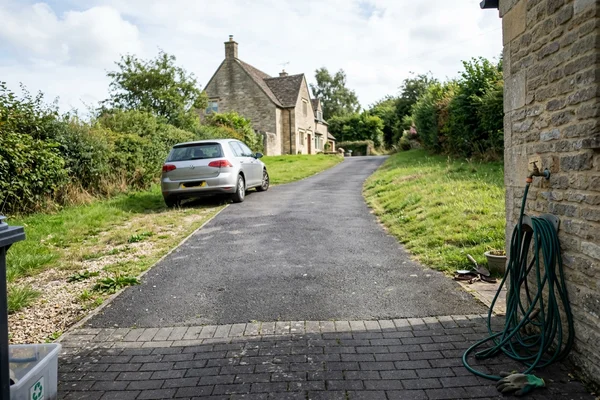 Long tarmac driveway with a block paved entrance apron at a Gloucestershire property