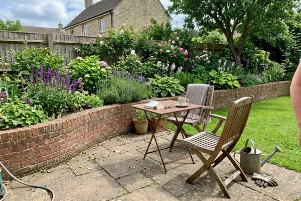 Patio seating area with a retaining edge and raised border planting