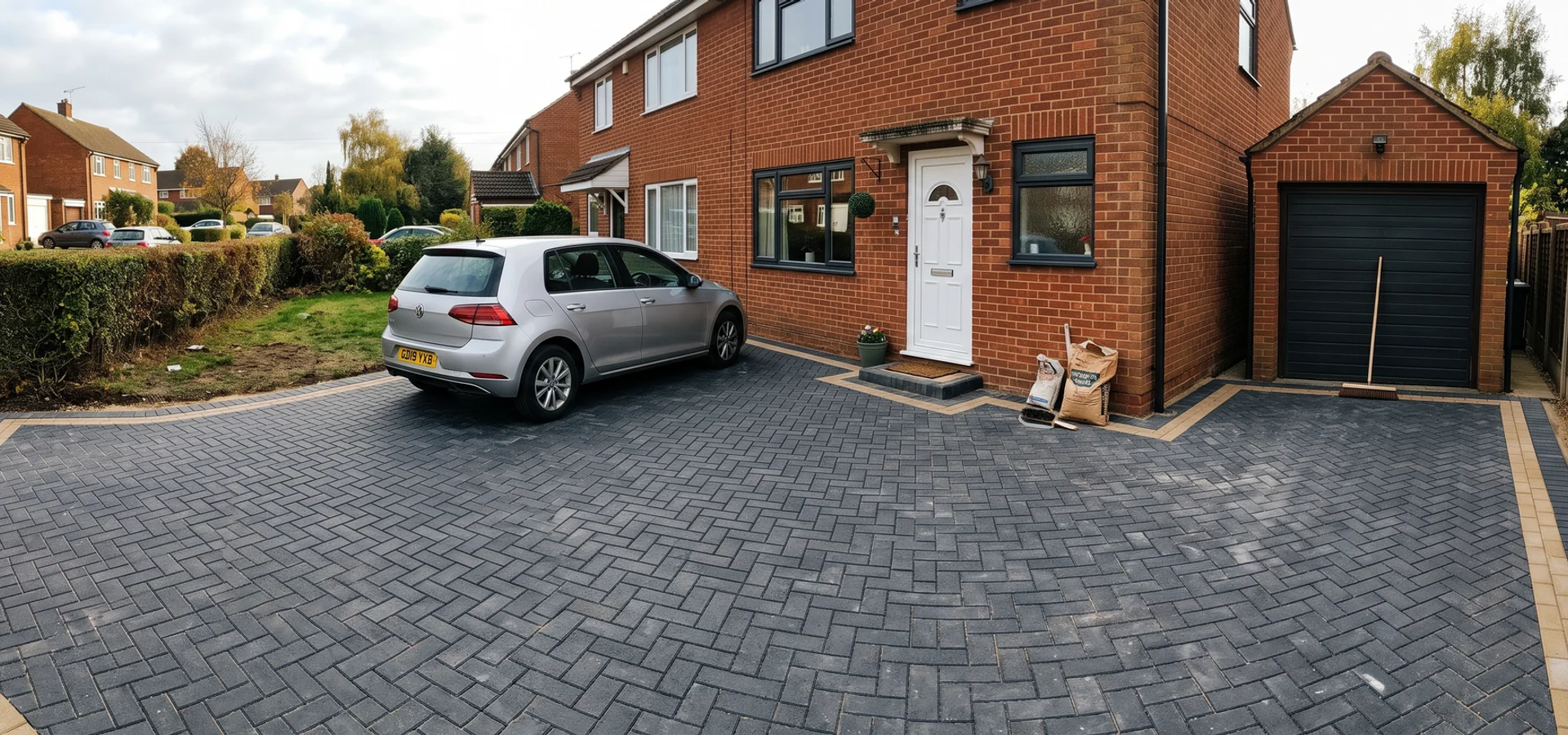 Newly laid block paving driveway in a herringbone pattern outside a Gloucester family home
