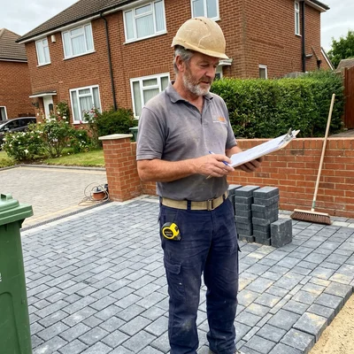 Gus, owner and lead installer at LayPave, on a freshly laid block paving driveway in Gloucester